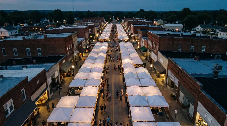 Looking down on a long street of identical white tents